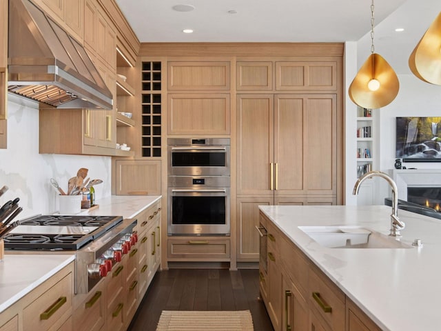 1111 River Pkwy Unit 33A, Minneapolis, MN 55415 - kitchen with under cabinet range hood, a sink, stainless steel appliances, light countertops, and dark wood-style floors