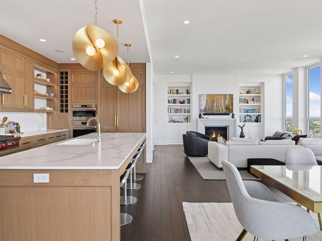 1111 River Pkwy Unit 33A, Minneapolis, MN 55415 - kitchen with a sink, stainless steel double oven, stovetop, a lit fireplace, and open shelves