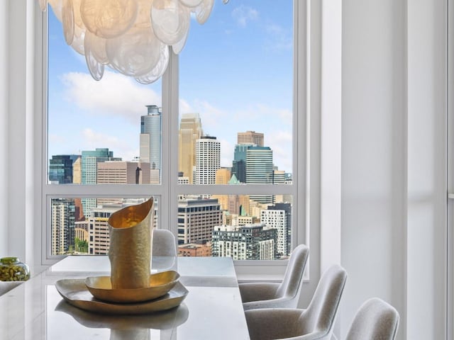 1111 River Pkwy Unit 33A, Minneapolis, MN 55415 - dining space featuring a view of skyline, a chandelier, and healthy amount of natural light