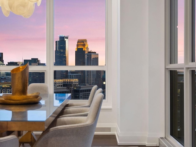 1111 River Pkwy Unit 33A, Minneapolis, MN 55415 - dining area with a skyline view, wood finished floors, and baseboards