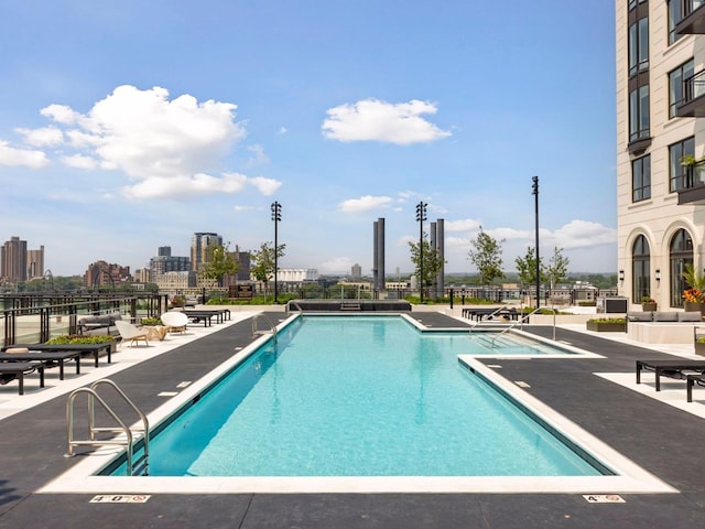 1111 River Pkwy Unit 33A, Minneapolis, MN 55415 - community pool featuring a patio area and a view of city