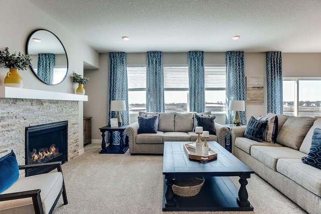 17090 Dimension Ave, Lakeville, MN 55044 - carpeted living area with a textured ceiling, a stone fireplace, and baseboards