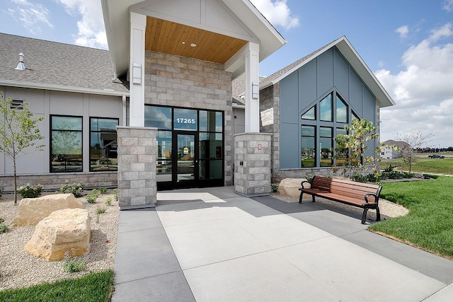 17090 Dimension Ave, Lakeville, MN 55044 - property entrance with stone siding, a shingled roof, and board and batten siding