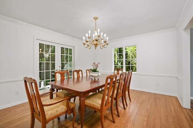 5705 Camelback Dr, Edina, MN 55436 - dining room featuring light wood-style floors, french doors, ornamental molding, a chandelier, and baseboards