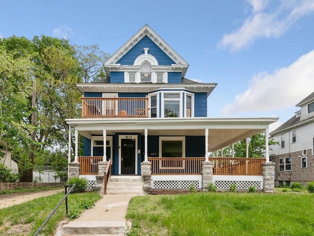 2613 Bryant Ave S, Minneapolis, MN 55408 - view of front of property featuring a balcony, covered porch, and a front yard