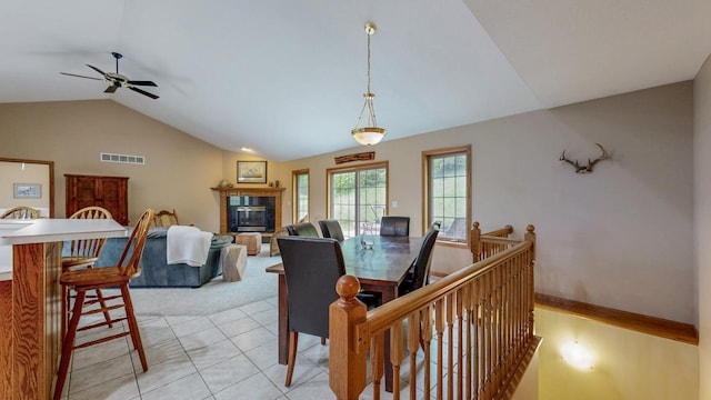 9484 Branch Rd SE, Chatfield, MN 55923 - dining space with lofted ceiling, ceiling fan, a fireplace, light tile patterned flooring, and light colored carpet