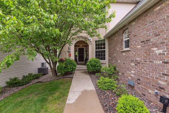 18764 Farmstead Cir, Eden Prairie, MN 55347 - doorway to property with stucco siding, cooling unit, and crawl space