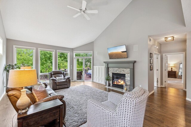 18764 Farmstead Cir, Eden Prairie, MN 55347 - living room featuring high vaulted ceiling, a stone fireplace, ceiling fan, baseboards, and wood finished floors