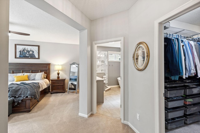 18764 Farmstead Cir, Eden Prairie, MN 55347 - bedroom with light colored carpet, a textured ceiling, baseboards, a closet, and ensuite bath