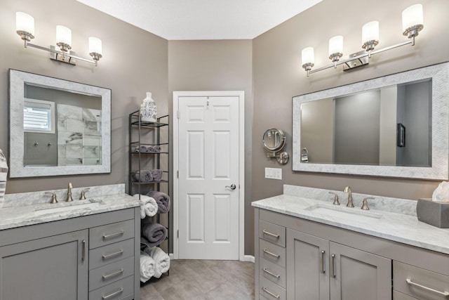 18764 Farmstead Cir, Eden Prairie, MN 55347 - bathroom featuring two vanities, tile patterned floors, and a tile shower