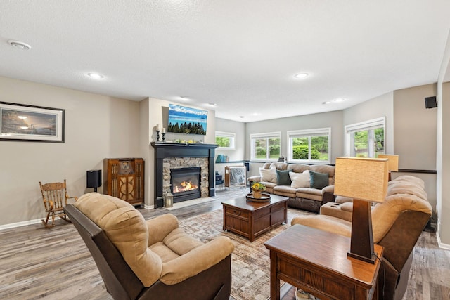 18764 Farmstead Cir, Eden Prairie, MN 55347 - living room with light wood-type flooring, a stone fireplace, baseboards, and recessed lighting
