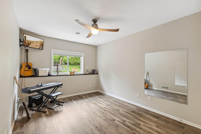 18764 Farmstead Cir, Eden Prairie, MN 55347 - home office with wood finished floors, a ceiling fan, a textured ceiling, and baseboards