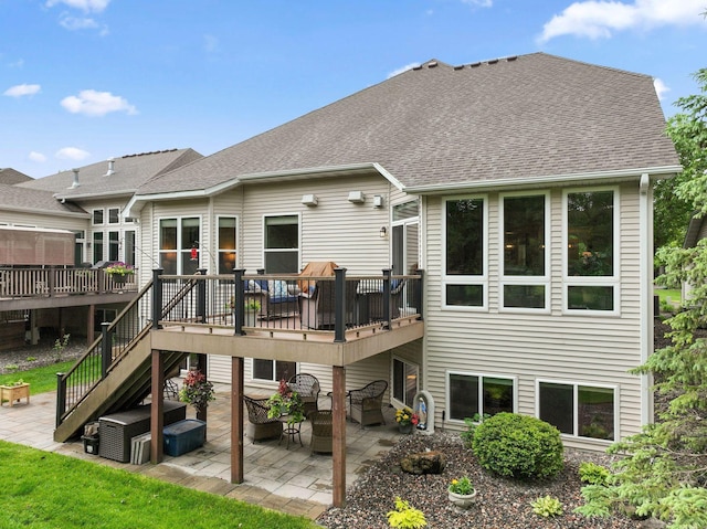 18764 Farmstead Cir, Eden Prairie, MN 55347 - rear view of house featuring a wooden deck, a patio, and roof with shingles