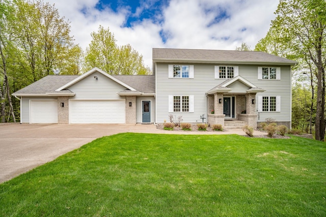 4975 Maribe Dr, Hermantown, MN 55811 - colonial home featuring a garage, concrete driveway, a front yard, brick siding, and roof with shingles