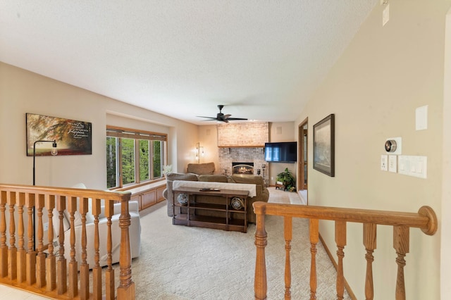 4975 Maribe Dr, Hermantown, MN 55811 - living room with ceiling fan, light colored carpet, a fireplace, and a textured ceiling
