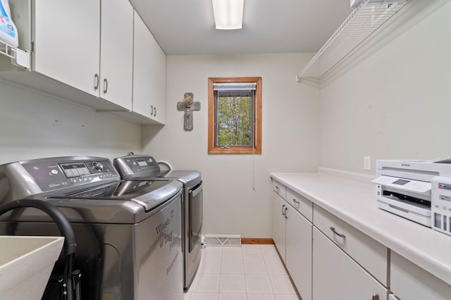 4975 Maribe Dr, Hermantown, MN 55811 - laundry area featuring washer and clothes dryer, cabinet space, baseboards, and light tile patterned floors