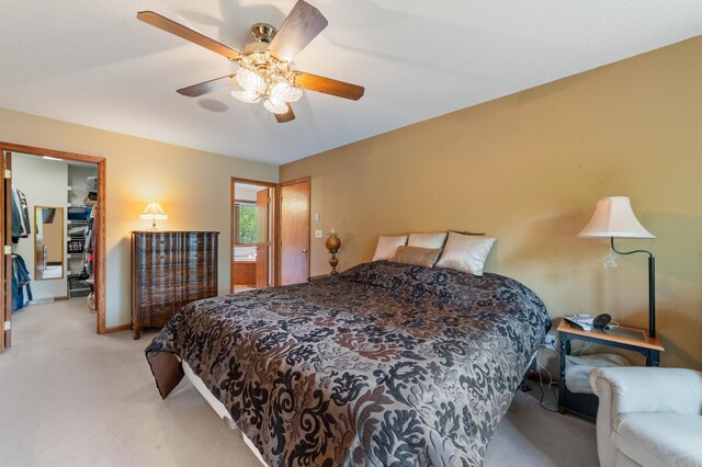 4975 Maribe Dr, Hermantown, MN 55811 - bedroom with light colored carpet, a walk in closet, a ceiling fan, a closet, and baseboards