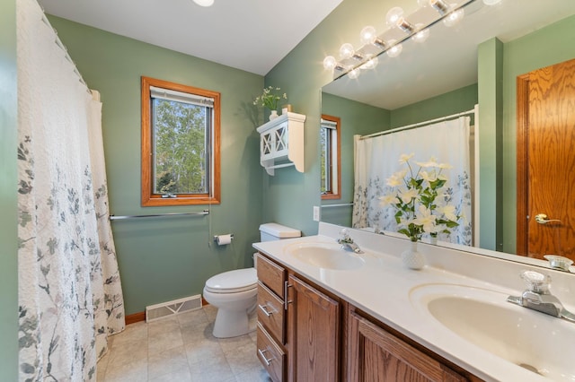4975 Maribe Dr, Hermantown, MN 55811 - full bath featuring double vanity, toilet, baseboards, tile patterned floors, and a shower with curtain