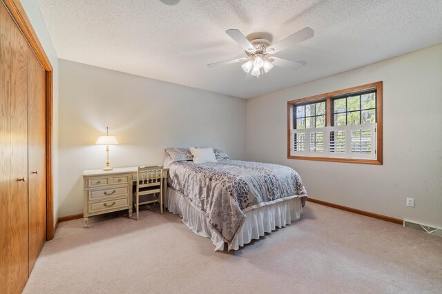 4975 Maribe Dr, Hermantown, MN 55811 - bedroom featuring carpet floors, baseboards, a closet, a ceiling fan, and a textured ceiling