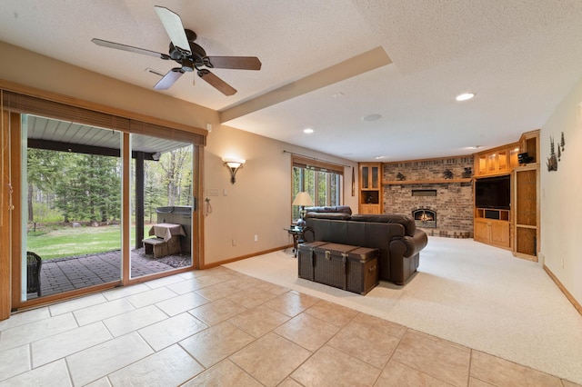 4975 Maribe Dr, Hermantown, MN 55811 - tiled living area featuring baseboards, a brick fireplace, a ceiling fan, carpet floors, and a textured ceiling