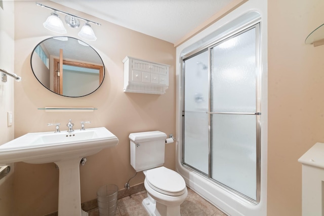 4975 Maribe Dr, Hermantown, MN 55811 - full bathroom with an enclosed shower, toilet, tile patterned floors, baseboards, and a sink