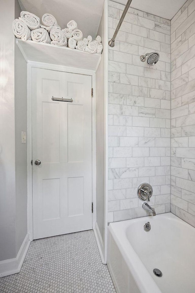 full bathroom featuring baseboards and  shower combination