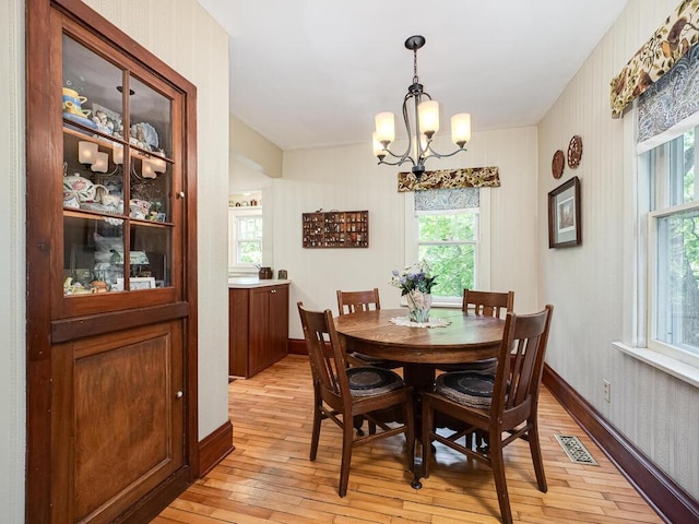 15210 Mckenzie Blvd, Minnetonka, MN 55345 - dining area with a chandelier, light wood finished floors, and baseboards