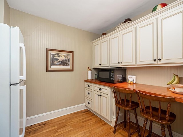 15210 Mckenzie Blvd, Minnetonka, MN 55345 - office area with built in study area, light wood-style flooring, and baseboards