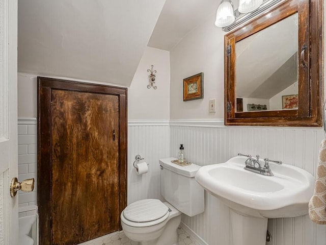 15210 Mckenzie Blvd, Minnetonka, MN 55345 - half bathroom with toilet, vaulted ceiling, and wainscoting