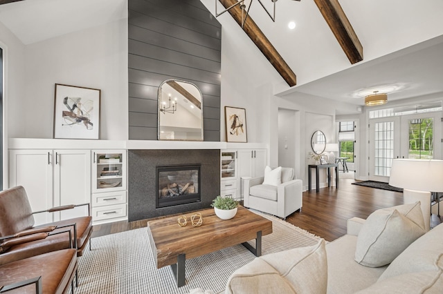 202 176th Ln NE, Ham Lake, MN 55304 - living area with wood finished floors, beam ceiling, a glass covered fireplace, and high vaulted ceiling
