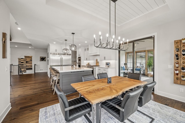 202 176th Ln NE, Ham Lake, MN 55304 - dining room featuring a chandelier, baseboards, dark wood-type flooring, and recessed lighting