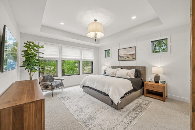 202 176th Ln NE, Ham Lake, MN 55304 - bedroom featuring a raised ceiling, multiple windows, light carpet, baseboards, and recessed lighting