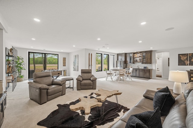 202 176th Ln NE, Ham Lake, MN 55304 - living area featuring light colored carpet, recessed lighting, plenty of natural light, and bar area