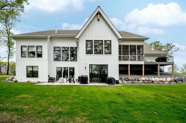 202 176th Ln NE, Ham Lake, MN 55304 - back of house with board and batten siding, a yard, a patio area, and roof with shingles