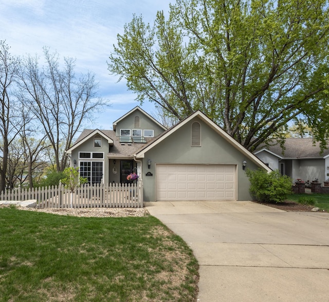 2513 Aspen Ln SW, Rochester, MN 55902 - traditional-style home featuring stucco siding, a garage, and concrete driveway
