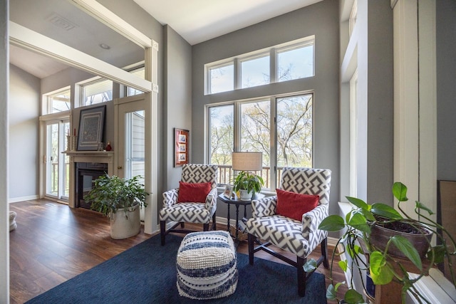 2513 Aspen Ln SW, Rochester, MN 55902 - living area with plenty of natural light, wood finished floors, a towering ceiling, and a glass covered fireplace