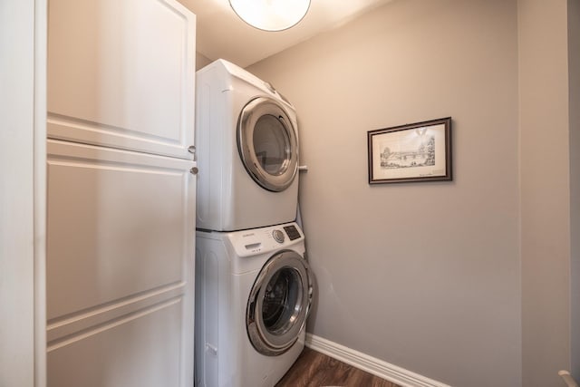 2513 Aspen Ln SW, Rochester, MN 55902 - laundry area with stacked washer / drying machine, cabinet space, baseboards, and dark wood-type flooring