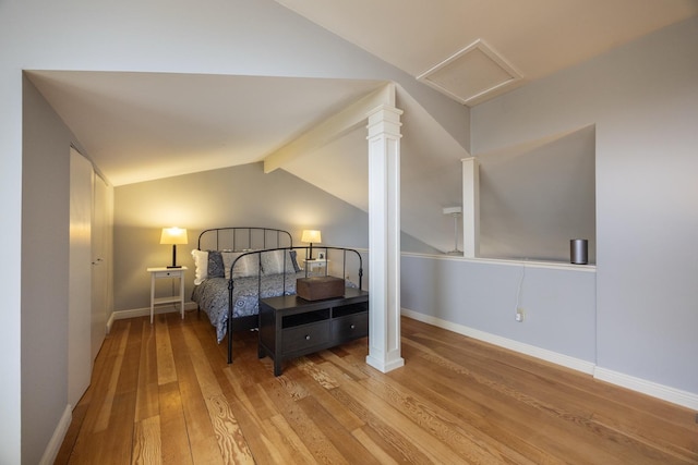 2513 Aspen Ln SW, Rochester, MN 55902 - bedroom featuring wood finished floors, baseboards, and attic access