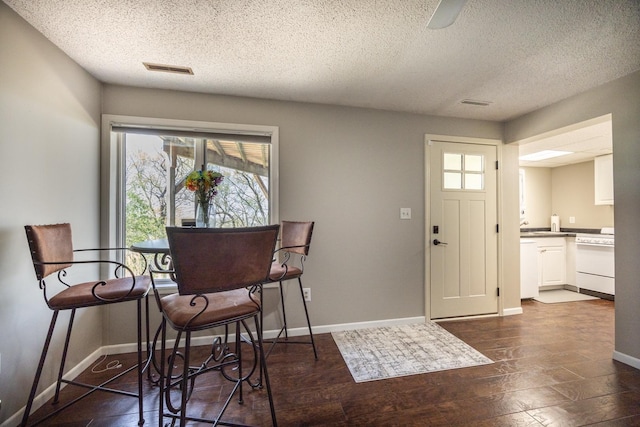 2513 Aspen Ln SW, Rochester, MN 55902 - dining room with a textured ceiling, baseboards, and dark wood-type flooring