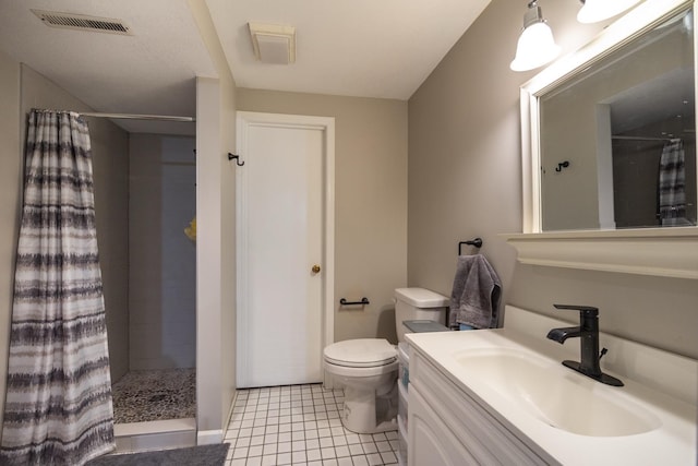 2513 Aspen Ln SW, Rochester, MN 55902 - full bathroom with a tile shower, toilet, vanity, and tile patterned floors
