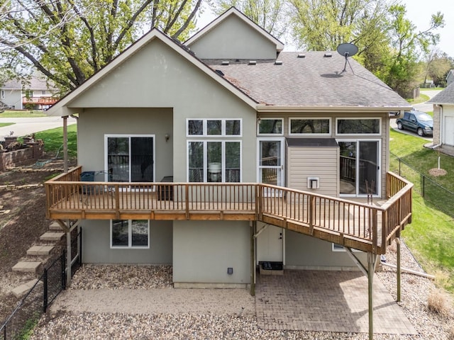 2513 Aspen Ln SW, Rochester, MN 55902 - back of house with a wooden deck, a shingled roof, a patio area, and stucco siding