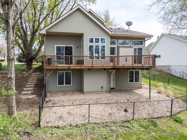 2513 Aspen Ln SW, Rochester, MN 55902 - rear view of house featuring a patio, a wooden deck, stairway, stucco siding, and fence