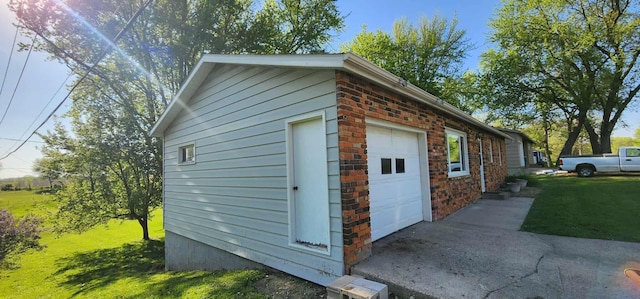 410 Wedgewood Rd, Albert Lea, MN 56007 - view of side of home with a garage, brick siding, and a yard
