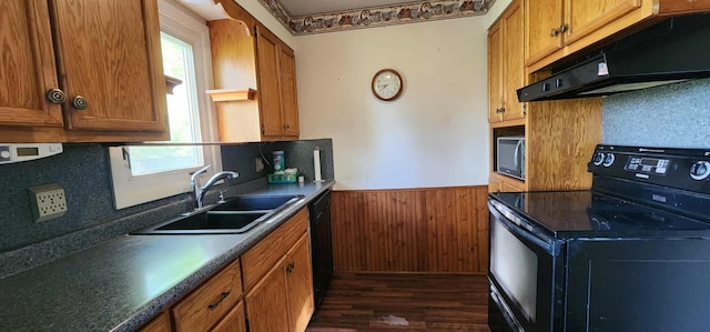 410 Wedgewood Rd, Albert Lea, MN 56007 - kitchen featuring black appliances, a sink, under cabinet range hood, wainscoting, and dark wood-type flooring