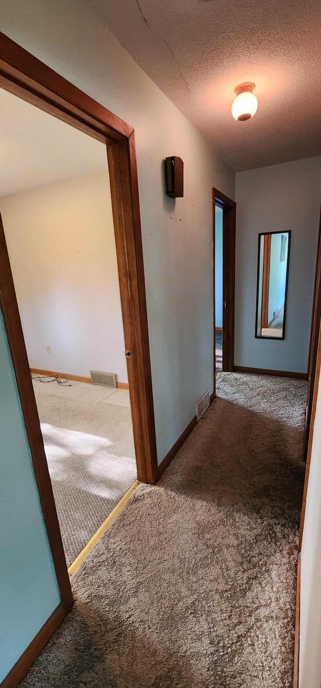 410 Wedgewood Rd, Albert Lea, MN 56007 - hall featuring carpet flooring, a textured ceiling, and baseboards