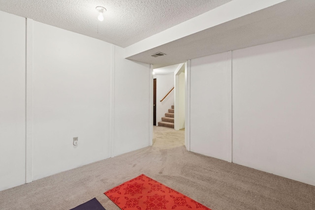 1039 Briar Creek Rd, Eagan, MN 55123 - finished basement with carpet floors, stairway, and a textured ceiling