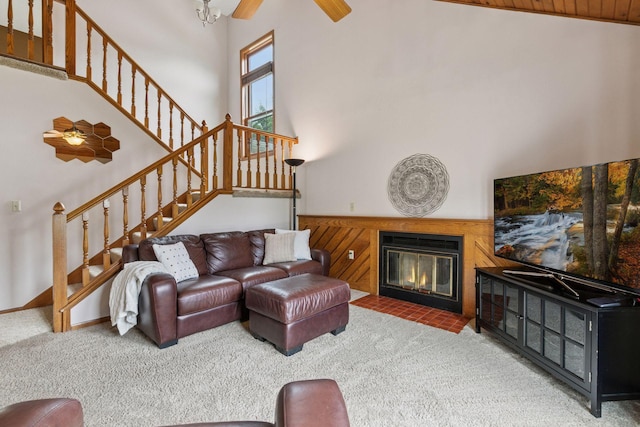 1039 Briar Creek Rd, Eagan, MN 55123 - living area with carpet flooring, a towering ceiling, stairs, a ceiling fan, and a fireplace with flush hearth