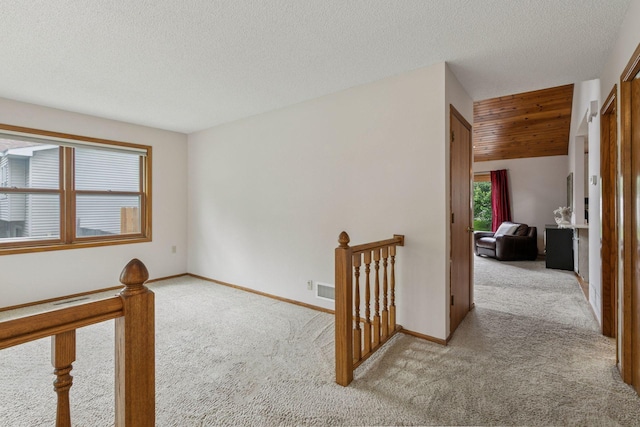 1039 Briar Creek Rd, Eagan, MN 55123 - empty room featuring light colored carpet, a textured ceiling, and baseboards