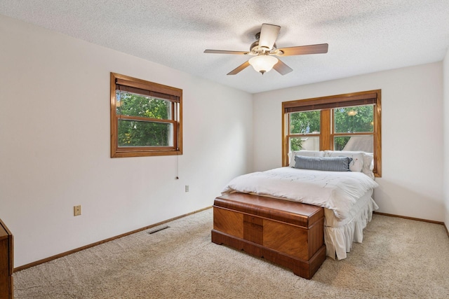 1039 Briar Creek Rd, Eagan, MN 55123 - carpeted bedroom with baseboards, a textured ceiling, and ceiling fan