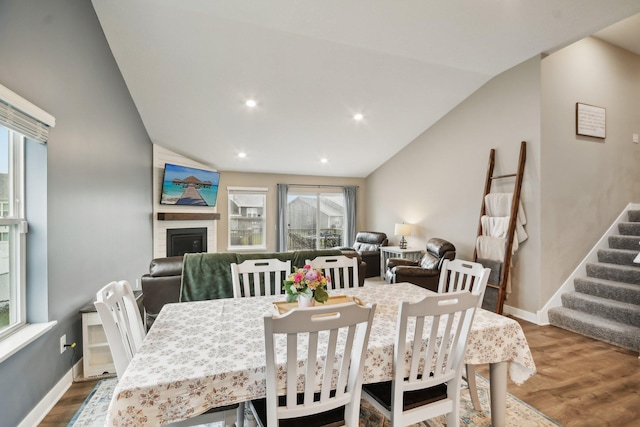 7516 Ochoa Ave NE, Otsego, MN 55330 - dining area with plenty of natural light, wood finished floors, vaulted ceiling, stairway, and recessed lighting